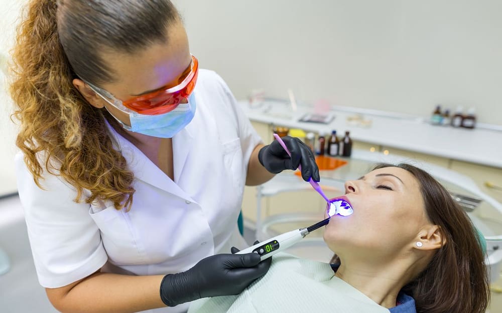 A woman is getting her teeth checked by a dentist - sedation-dentistry-can-help-manage-dental-anxiety
