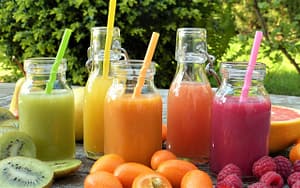 A selection of fruit juices are displayed on a table.