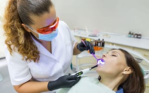 A woman is getting her teeth checked by a dentist - sedation-dentistry-can-help-manage-dental-anxiety